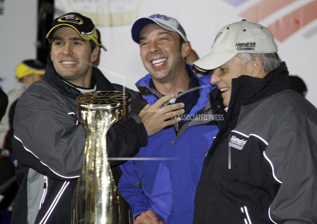 Terry Renna FILE - In this Saturday, Oct. 17, 2009, file photo, Jimmie Johnson, left, jokes with crew chief Chad Knaus, center, and team owner Rick Hendrick, right, after winning the NASCAR Banking 500 Sprint Cup Series auto race at Lowe's Motor Speedway in Concord, N.C. Chad Knaus will move off the pit stand and into a management role with Hendrick Motorsports, ending his crew chief career after seven championships. Hendrick on Tuesday, Sept. 29, 2020, announced Knaus will move to vice president of competition. (AP Photo/Terry Renna, File)