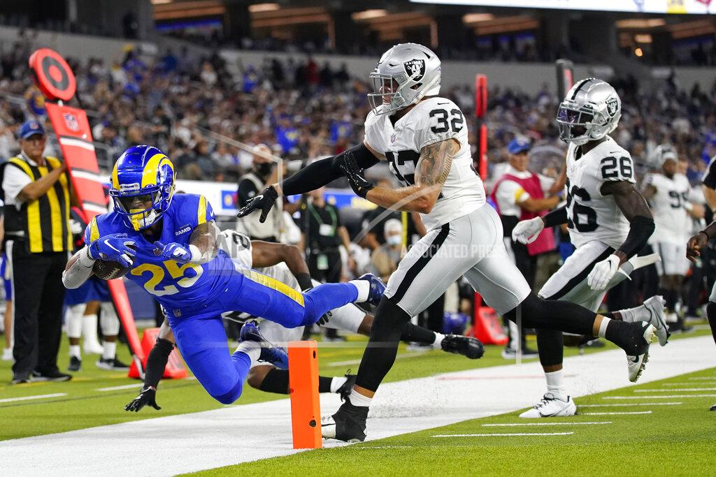 Los Angeles Rams running back Xavier Jones, left, is pushed out of bounds near the end zone by Las Vegas Raiders defensive back Dallin Leavitt (32) during the first half of a preseason NFL football game Saturday, Aug. 21, 2021, in Inglewood, Calif. (AP Photo/Ashley Landis)
