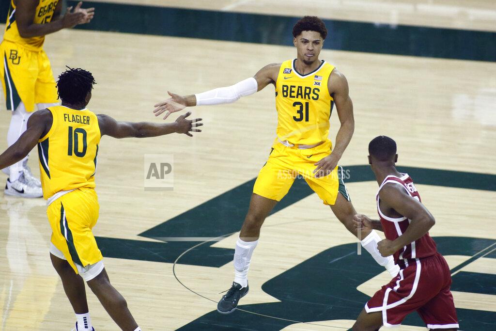 Ray Carlin Baylor guard Adam Flagler, left, and Baylor guard MaCio Teague, right, slap hands after a basket against the Oklahoma during the second half of an NCAA college basketball game on Wednesday, Jan. 6, 2021, in Waco, Texas. (AP Photo/Ray Carlin)