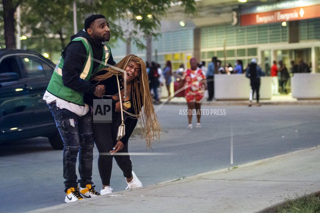 Ashlee Rezin Garcia Hundreds of mourners gather in the parking lot of Stroger Hospital after a 40-year-old man was shot to death in the 700 block of North Spaulding Avenue on Memorial Day, Monday night, May 31, 2021, in Chicago. (Ashlee Rezin Garcia/Chicago Sun-Times via AP)