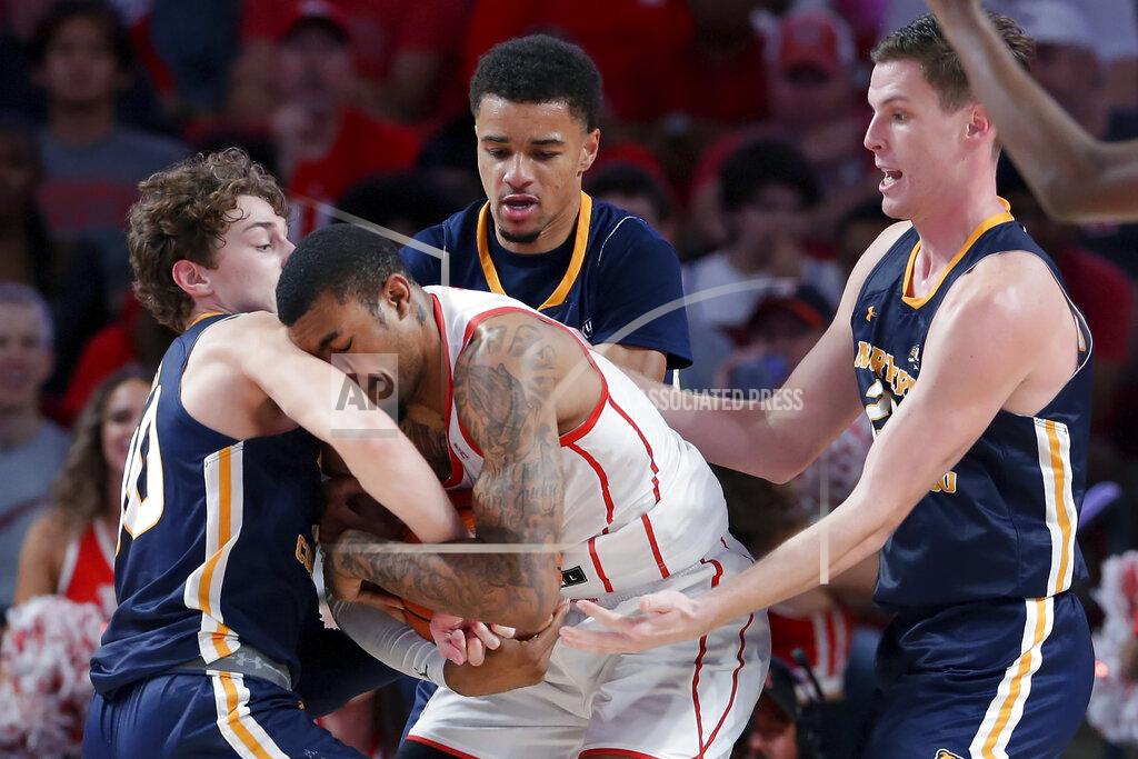 Michael Wyke Houston forward Reggie Chaney, center, collides with Northern Colorado guard Caleb Shaw, left, as he attempts to grab the ball while Northern Colorado guard Daylen Kountz, center back, and forward Riley Abercrombie, right, look on during the second half of an NCAA college basketball game Monday, Nov. 7, 2022, in Houston. (AP Photo/Michael Wyke)