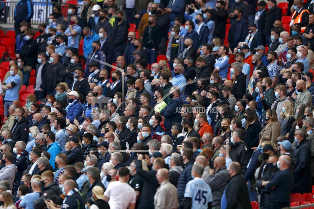 Alastair Grant Manchester City fans stand up during the English League Cup final soccer match between Manchester City and Tottenham Hotspur at Wembley stadium in London, Sunday, April 25, 2021. Some eight thousand spectators were allowed in the stadium. (AP Photo/Alastair Grant)