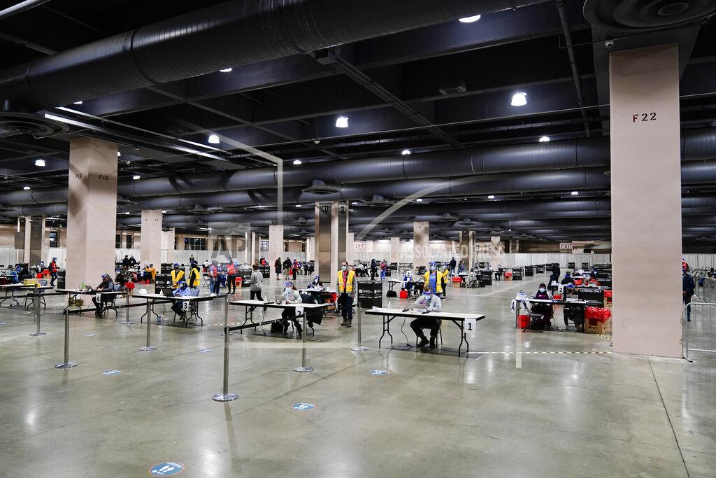 A COVID-19 vaccination site is set up at the Pennsylvania Convention Center in Philadelphia, Wednesday, Feb. 3, 2021. The clinic opened to help provide second doses of the vaccine. (AP Photo/Matt Rourke)