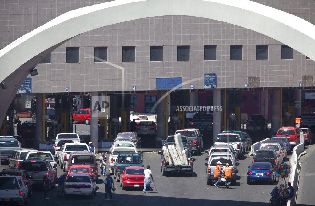 FILE - This June 1, 2009, file photo, shows vehicles waiting to enter the U.S. through The Dennis DeConcini Port of Entry in downtown Nogales, Ariz. For months, the U.S. has barred asylum seekers from approaching official crossings to file a claim. Now, some are rushing the ports by running through vehicle lanes to evade the process used to officially request asylum. That is causing massive delays at crossings in Arizona as U.S. Customs and Border Protection officials have barricaded lanes used by cars to legally enter the U.S. (Mark Henle/The Arizona Republic via AP, File)