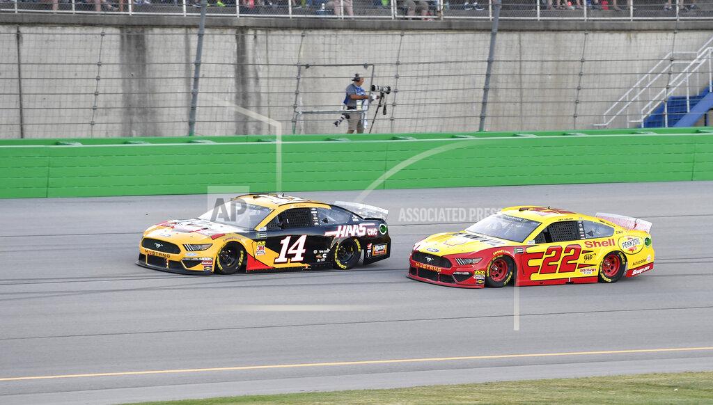 Timothy D. Easley Clint Bowyer (14) attempts to hold off the challenge of Joey Logano (22) during the NASCAR Cup Series auto race at Kentucky Speedway in Sparta, Ky., Saturday, July 13, 2019. (AP Photo/Timothy D. Easley)