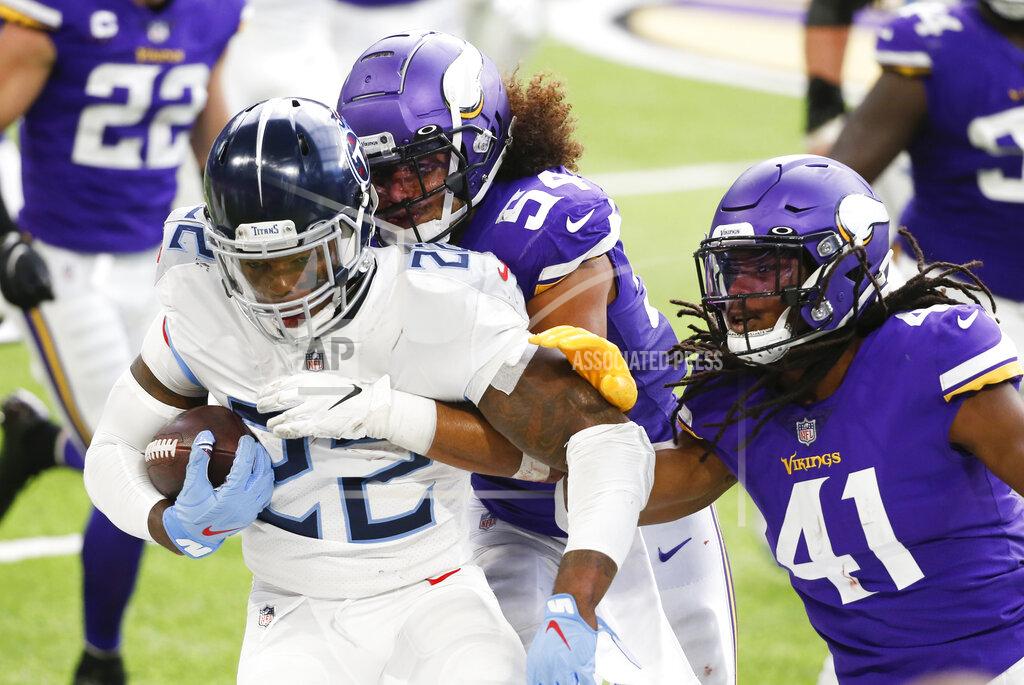 Bruce Kluckhohn Tennessee Titans running back Derrick Henry (22) is tackled by Minnesota Vikings middle linebacker Eric Kendricks (54) and free safety Anthony Harris (41) during the first half of an NFL football game, Sunday, Sept. 27, 2020, in Minneapolis. (AP Photo/Bruce Kluckhohn)