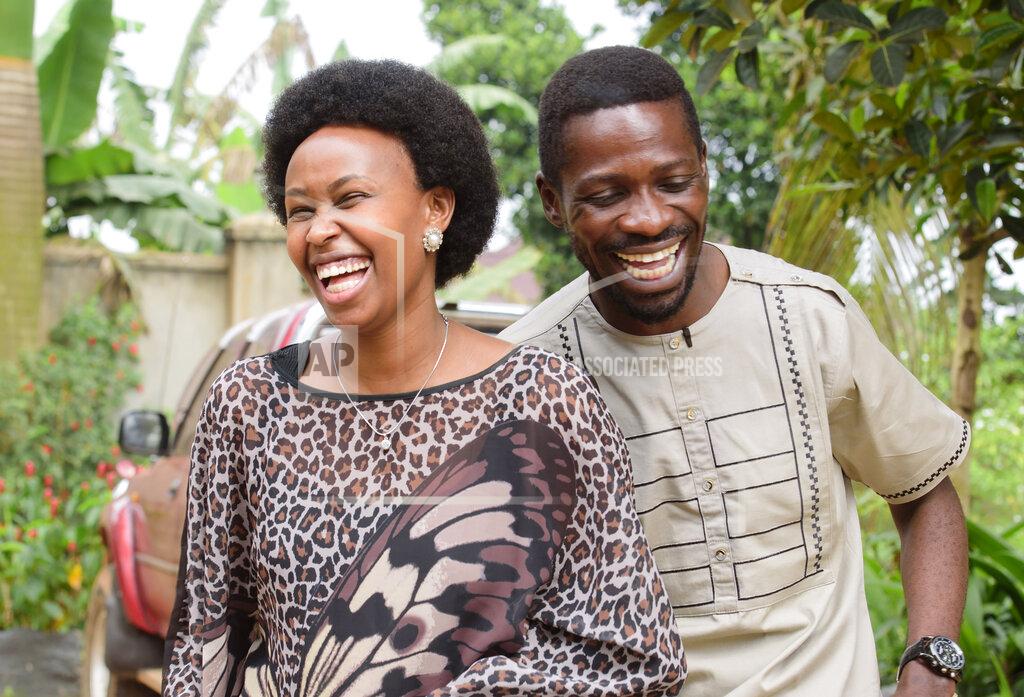 Nicholas Bamulanzeki Uganda's leading opposition challenger Bobi Wine, right, and his wife Barbie Kyagulanyi, in cheerful mood after casting their votes in Kampala, Uganda, Thursday, Jan. 14, 2021. Ugandans are voting in a presidential election tainted by widespread violence that some fear could escalate as security forces try to stop supporters of Wine from monitoring polling stations.(AP Photo/Nicholas Bamulanzeki)