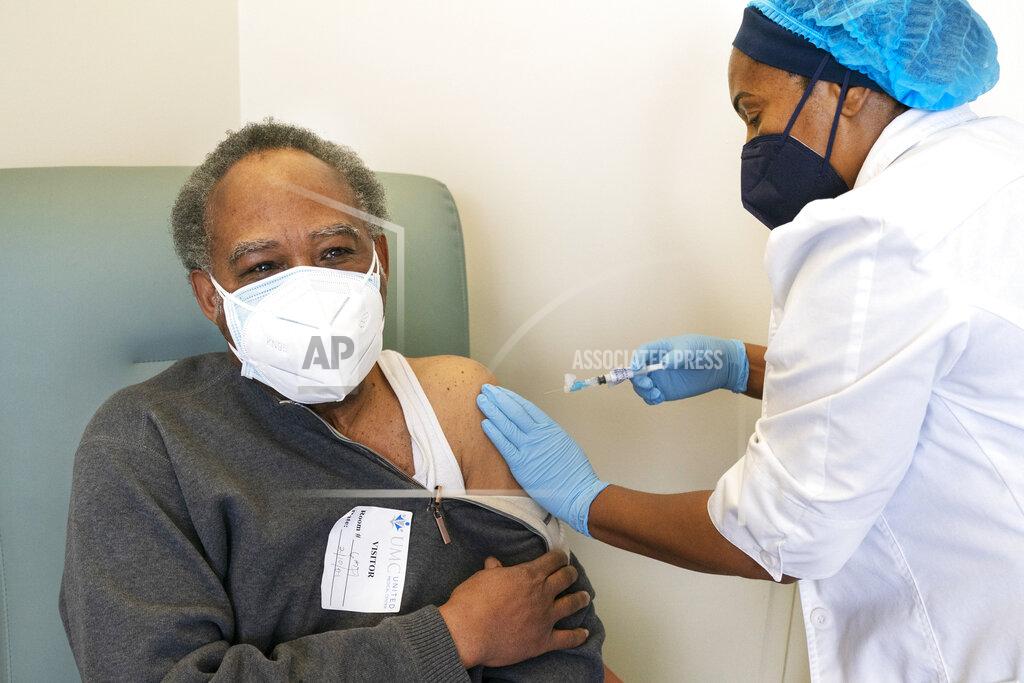 Jacquelyn Martin In this Wednesday, Feb. 10, 2021, photo the Rev. James Coleman, 70, is vaccinated for COVID-19 by nurse practitioner Ifreke Udodong at United Medical Center in southeast Washington. (AP Photo/Jacquelyn Martin)
