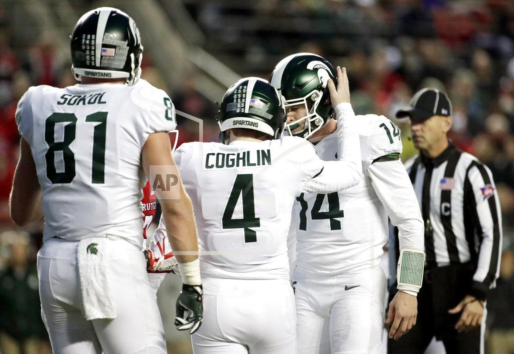 Julio Cortez Michigan State placekicker Matt Coghlin (4) is congratulated by Brian Lewerke, right, after making a field goal against Rutgers during the first half of an NCAA college football game, Saturday, Nov. 25, 2017, in Piscataway, N.J. (AP Photo/Julio Cortez)