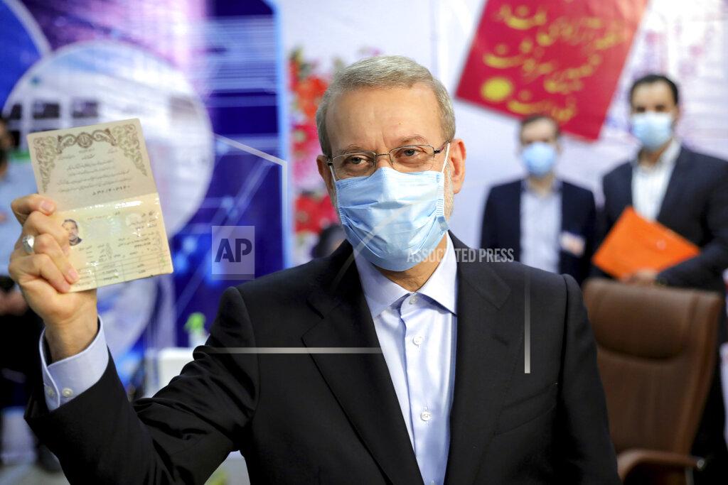 Ebrahim Noroozi Former Iranian parliament speaker Ali Larijani shows his identification document while registering his name as a candidate for the June 18 presidential elections at elections headquarters of the Interior Ministry in Tehran, Iran, Saturday, May 15, 2021. (AP Photo/Ebrahim Noroozi)