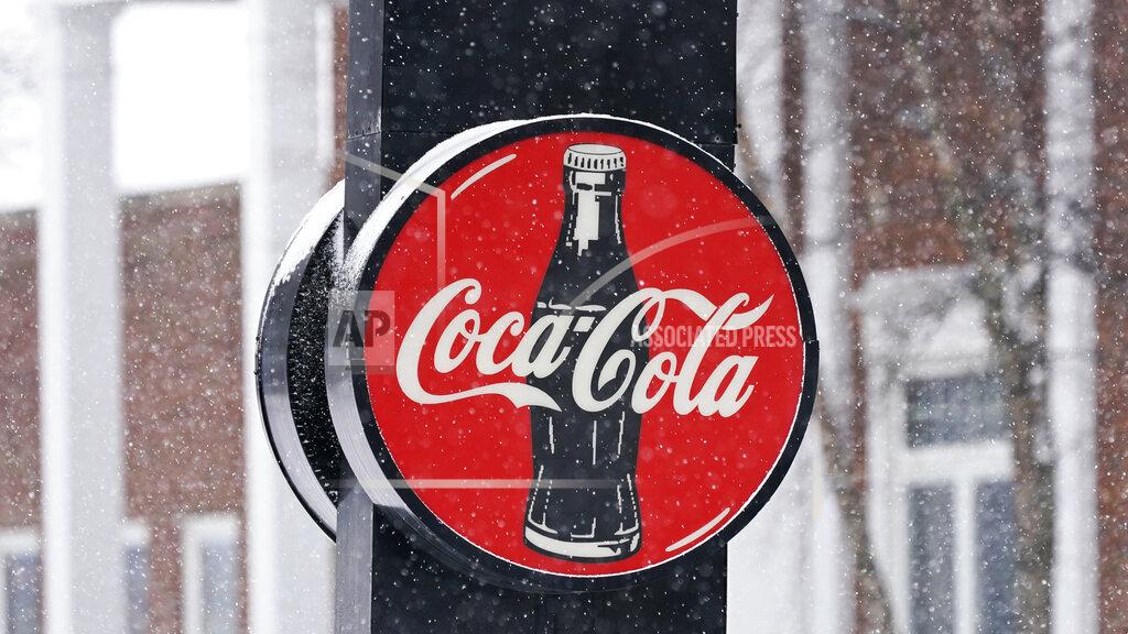Tony Dejak A Coca-Cola sign hangs outside a Coca-Cola distributor, Tuesday, Feb. 9, 2021, in Bedford, Ohio. The resurgent coronavirus slowed Coca-Cola’s recovery in the fourth quarter, and the company said the slump has continued through the first months of this year. (AP Photo/Tony Dejak)
