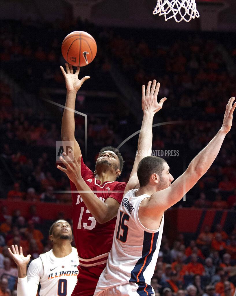 Stephen Haas Indiana forward Juwan Morgan (13) shoots between the defense of Illinois guard Alan Griffin (0) and forward Giorgi Bezhanishvili (15) during the second half of an NCAA college basketball game in Champaign, Ill., Thursday, March 7, 2019. (AP Photo/Stephen Haas)