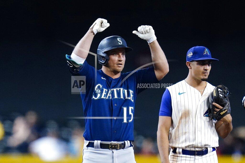 Ross D. Franklin Seattle Mariners' Kyle Seager (15) celebrates his two-run double as he stand on second base next to Arizona Diamondbacks shortstop Josh Rojas during the 11th inning of a baseball game Sunday, Sept. 5, 2021, in Phoenix. (AP Photo/Ross D. Franklin)