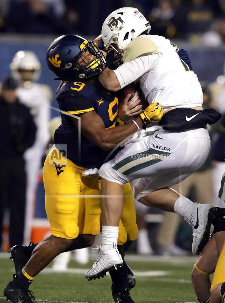 Ray Thompson West Virginia safety Jovanni Stewart (9) sacks Baylor quarterback Charlie Brewer, right, during the first half of an NCAA college football game Thursday, Oct. 25, 2018, in Morgantown, W.Va. (AP Photo/Raymond Thompson)