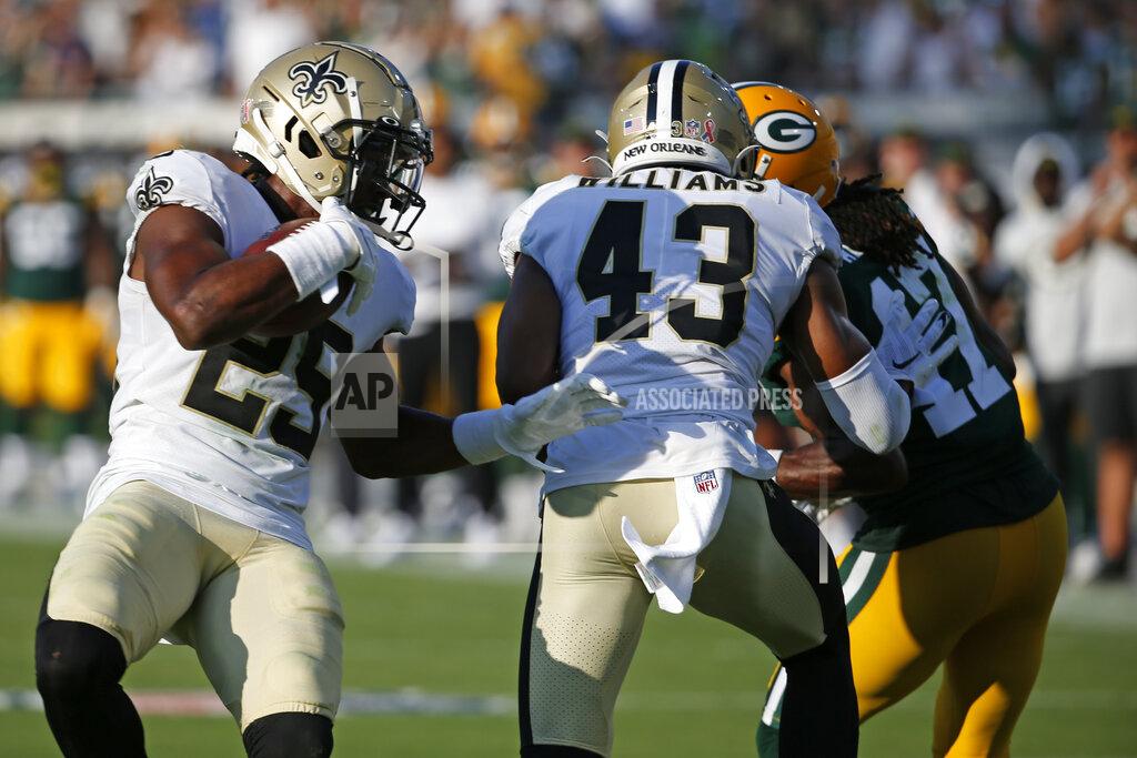 New Orleans Saints cornerback Paulson Adebo, left, intercepts a pass thrown by Green Bay Packers quarterback Aaron Rodgers during the second half of an NFL football game, Sunday, Sept. 12, 2021, in Jacksonville, Fla. (AP Photo/Stephen B. Morton)