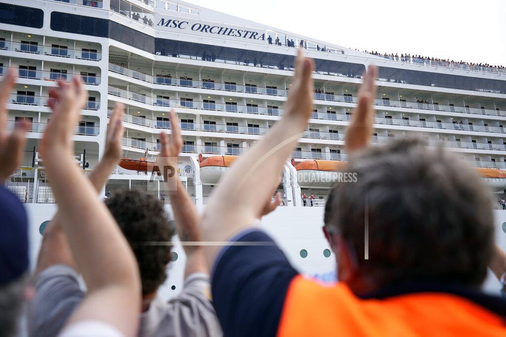 Antonio Calanni People applaud as the 92,409-ton, 16-deck MSC Orchestra cruise ship departs from Venice, Italy, Saturday, June 5, 2021. The first cruise ship leaving Venice since the pandemic is set to depart Saturday amid protests by activists demanding that the enormous ships be permanently rerouted out the fragile lagoon, especially Giudecca Canal through the city's historic center, due to environmental and safety risks. The cruiser passed two groups of protesters: pro-cruise advocates whose jobs depend on the industry as well as protesters belonging to a movement called "No Big Ships" who have been campaigning for years to get cruise ships out of the lagoon. (AP Photo/Antonio Calanni)