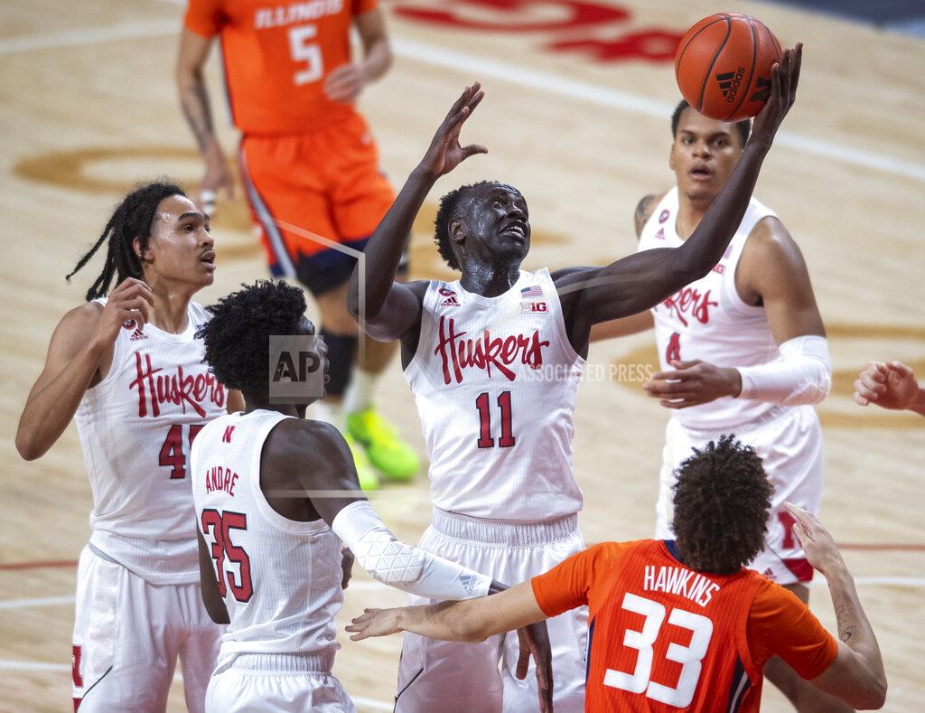 Francis Gardler Nebraska forward Lat Mayen (11) pulls in a defensive rebound next to Illinois' Coleman Hawkins (33) during the first half of an NCAA college basketball game Friday, Feb. 12, 2021, in Lincoln, Neb. (Francis Gardler/Lincoln Journal Star via AP)