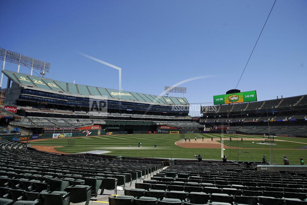 Jeff Chiu The grounds crew works on the field at Oakland Coliseum before an Oakland Athletics baseball practice in Oakland, Calif., Saturday, July 4, 2020. (AP Photo/Jeff Chiu)
