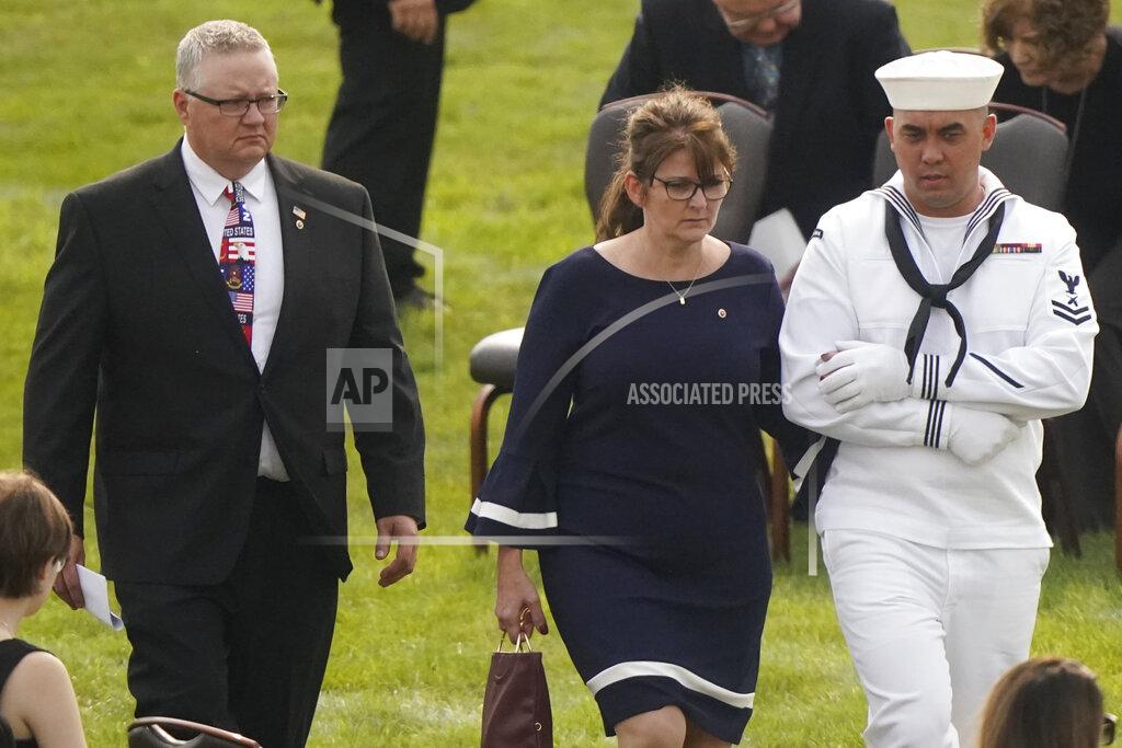 Tony Dejak Kip and Rachel Soviak, parents of Navy Corpsman Maxton Soviak, are escorted to their seats before the funeral of their son at Edison High School Stadium, Monday, Sept. 13, 2021, in Milan, Ohio. Maxton was one of 13 U.S. troops killed in a suicide bombing at Afghanistan's Kabul airport on Aug. 26. (AP Photo/Tony Dejak)