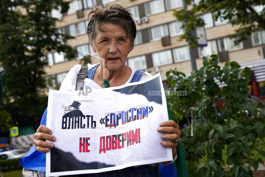 Alexander Zemlianichenko FILE - In this Aug. 14, 2021, file photo, an elderly opposition activist with a poster reading "we do not trust the power of United Russia party" attends an anti-vaccination protest in the center of Moscow, Russia. Imprisoned Russian opposition leader Navalny and his embattled allies won't be running in the Sept. 19 parliamentary election, but they still hope to challenge the ruling United Russia party with their strategy known as Smart Voting. (AP Photo/Alexander Zemlianichenko, File)