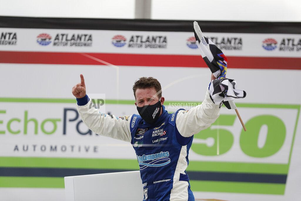 Brynn Anderson AJ Allmendinger celebrates after he won a NASCAR Xfinity Series auto race at Atlanta Motor Speedway, Saturday, June 6, 2020, in Hampton, Ga. (AP Photo/Brynn Anderson)