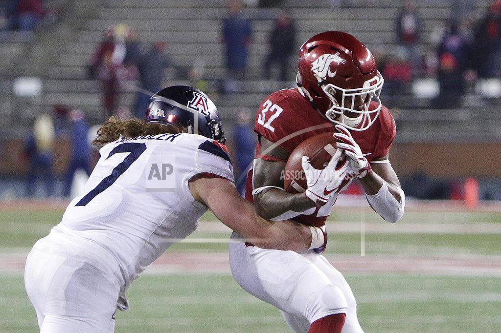 Young Kwak Washington State running back James Williams (32) tries to get away from Arizona linebacker Colin Schooler (7) wraps him up during the second half of an NCAA college football game in Pullman, Wash., Saturday, Nov. 17, 2018. Washington State won 69-28. (AP Photo/Young Kwak)