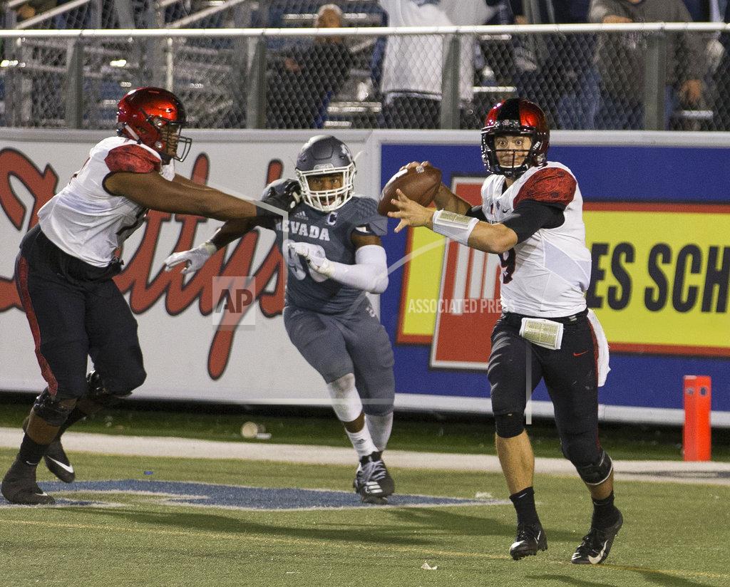 Tom R. Smedes San Diego State quarterback Ryan Agnew (9) looks to throw as he is chased by against Nevada's Korey Rush (90) in the second half of an NCAA college football game in Reno, Nev., Saturday, Oct. 27, 2018. (AP Photo/Tom R. Smedes)
