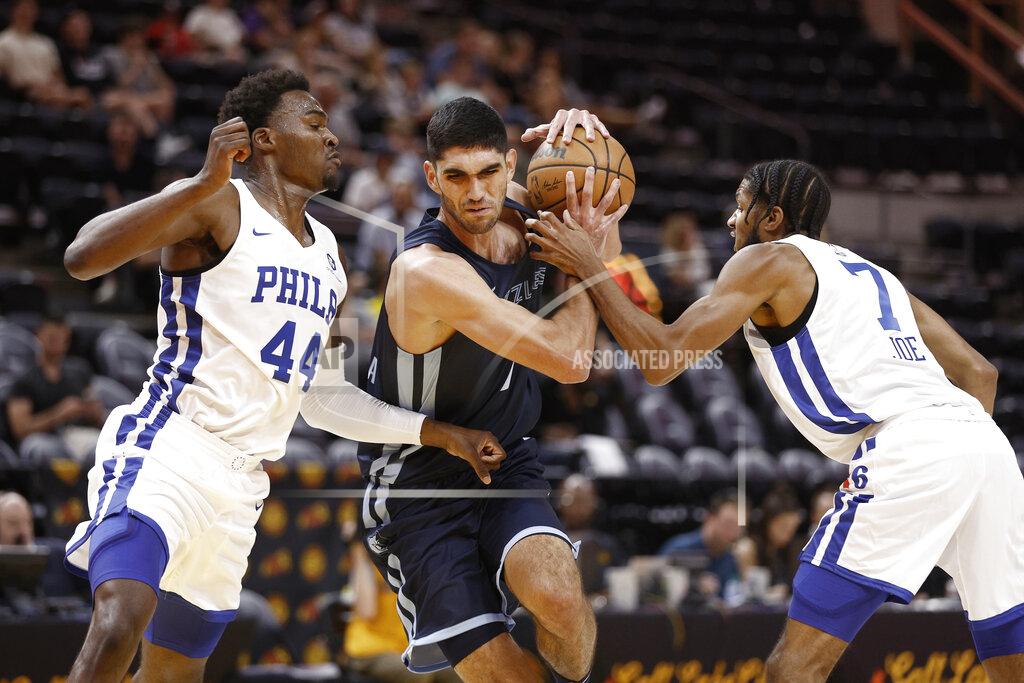 Jeff Swinger Memphis Grizzlies forward Santi Aldama (7) drives between Philadelphia 76ers forward Paul Reed Jr. (44) and guard Isaiah Joe (7) during the first quarter of an NBA summer league basketball game Tuesday, July 5, 2022, in Salt Lake City. (AP Photo/Jeff Swinger)