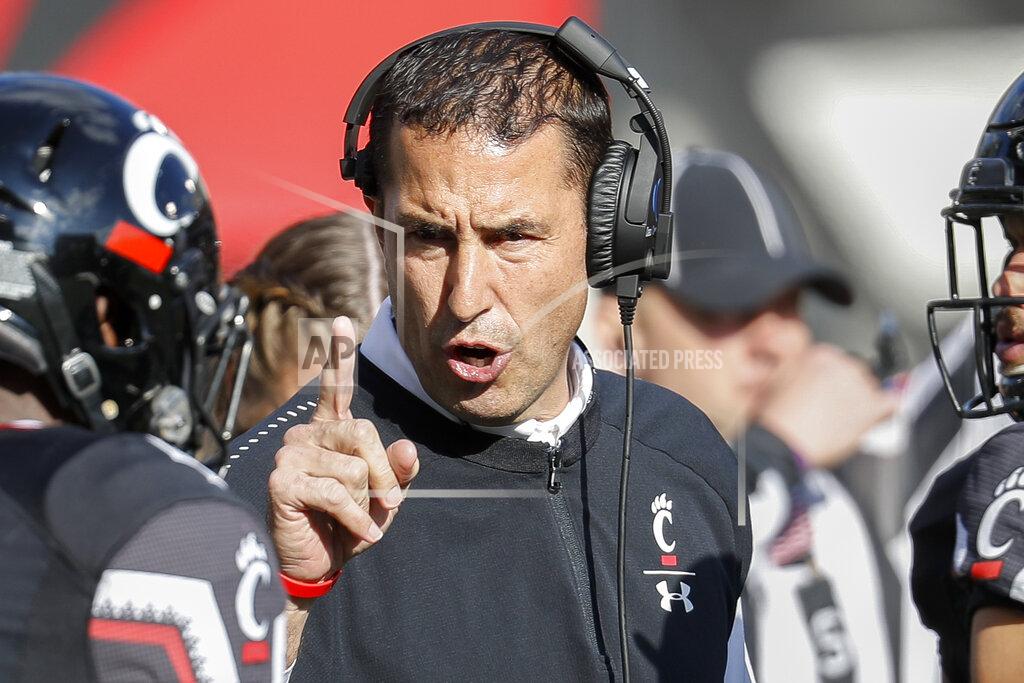 John Minchillo FILE - In this Saturday, Nov. 3, 2018, file photo, Cincinnati head coach Luke Fickell speaks with linebacker Malik Clements (4) before an NCAA college football game against Navy in Cincinnati. Cincinnati has lost 11 straight in the series since beating the Buckeyes in 1896 and ‘97. No. 5 Ohio State better be ready this time. Third-year Cincinnati coach Luke Fickell returns to Columbus, where he was born, played for the Buckeyes and was a longtime assistant and filled in as head coach in 2011. (AP Photo/John Minchillo, File)