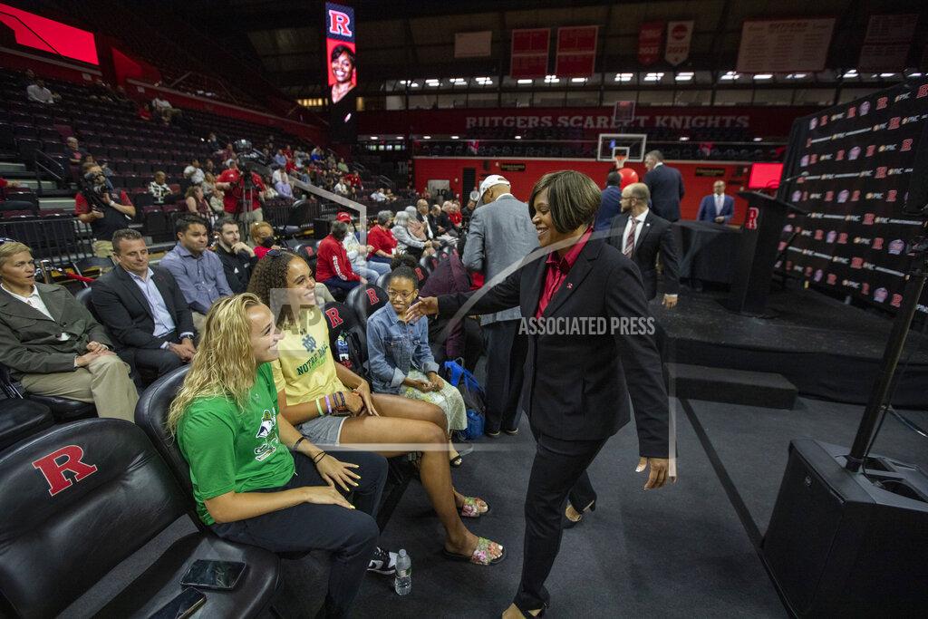 Andrew Mills Notre Dame basketball players Dara Mabrey and Natalija Marshall attend a news conference to introduce their former coach, Coquese Washington, right, as the new women's basketball coach at Rutgers on Tuesday, May 24, 2022 in Piscataway, N.J. Washington was the associate head coach at Notre Dame for two seasons before being hired by Rutgers this week. (Andrew Mills/NJ Advance Media via AP)