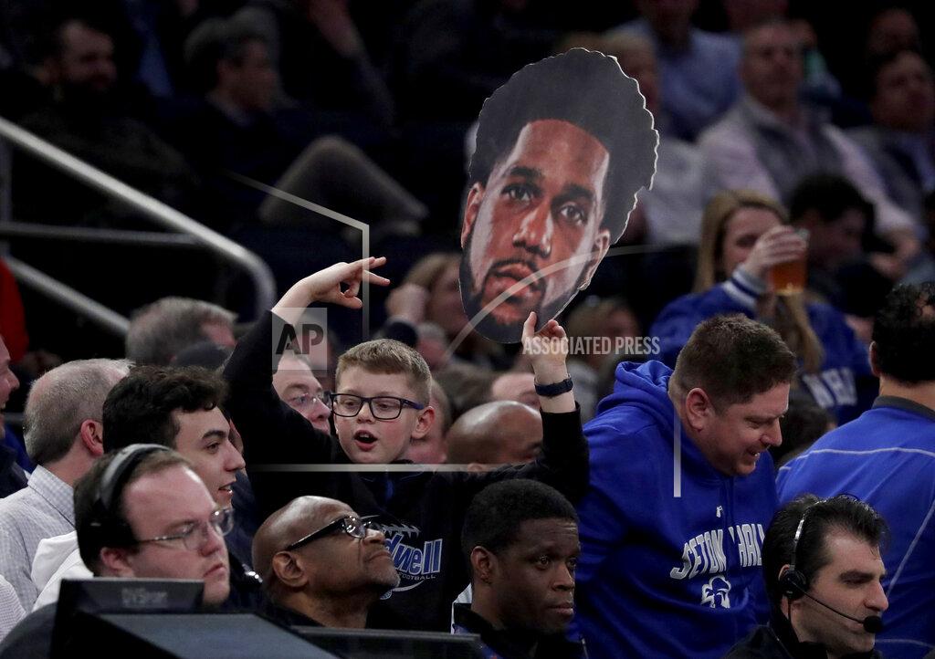 Julio Cortez A boy holds a photo with the likeness of Seton Hall guard Myles Powell during the first half of an NCAA college basketball game between Seton Hall and Georgetown in the Big East men's tournament, Thursday, March 14, 2019, in New York. (AP Photo/Julio Cortez)