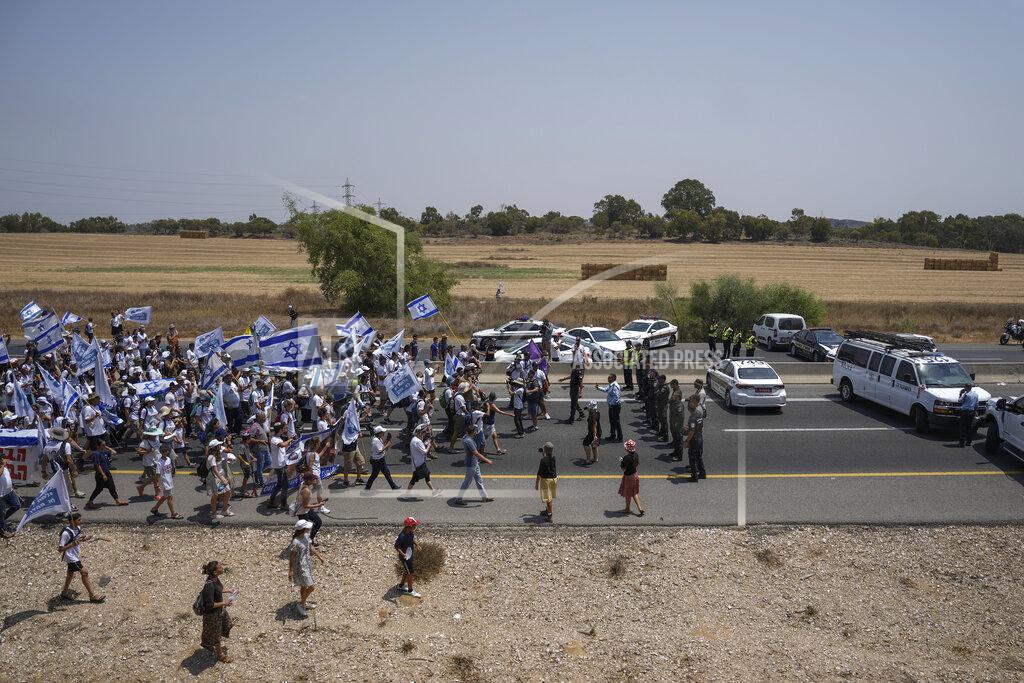 Ariel Schalit Israeli police officers try to block supporters and family members of Israeli soldier Hadar Goldin, killed during the 2014 conflict in the Gaza Strip, from marching towards the Gaza border near Kibbutz Yad Mordechai, southern Israel Friday, Aug. 5, 2022. The protesters call for the return of Goldin's and Israeli civilians held by Gaza's Hamas rulers back to Israel. The demonstration comes as Israel has closed all roads along Gaza border since Tuesday and sent reinforcements for fears of attacks from Gaza following the arrest of a senior Palestinian militant in the West Bank. (AP Photo/Ariel Schalit)