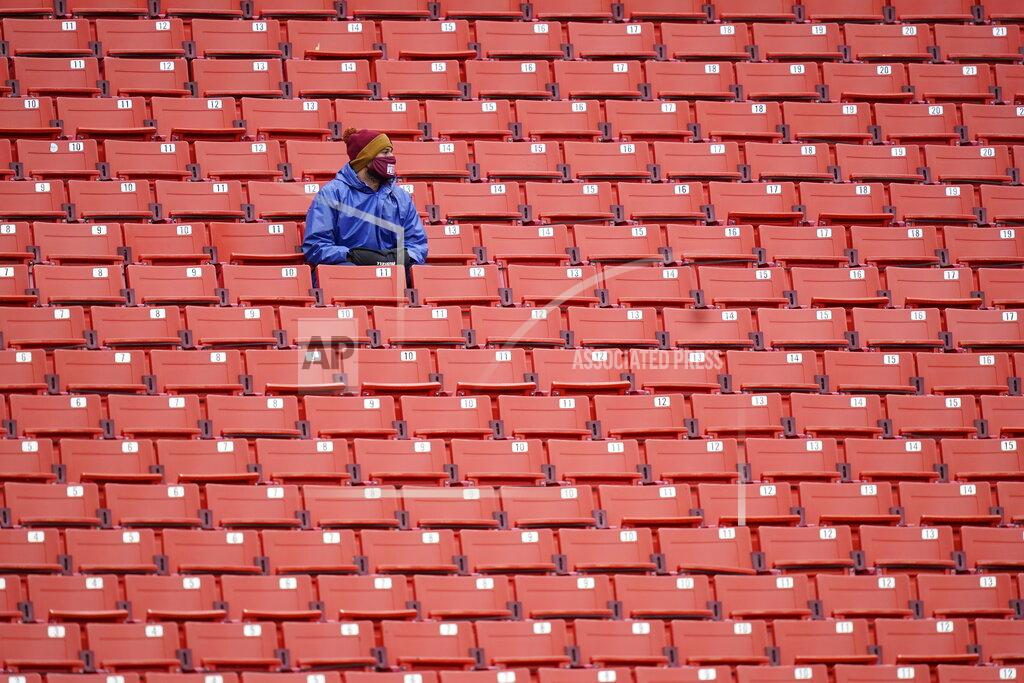 Patrick Semansky Fans sits in an empty seating section of Fedex Field during the first half of an NFL football game between Dallas Cowboys and Washington Football Team, Sunday, Oct. 25, 2020, in Landover, Md. (AP Photo/Patrick Semansky)