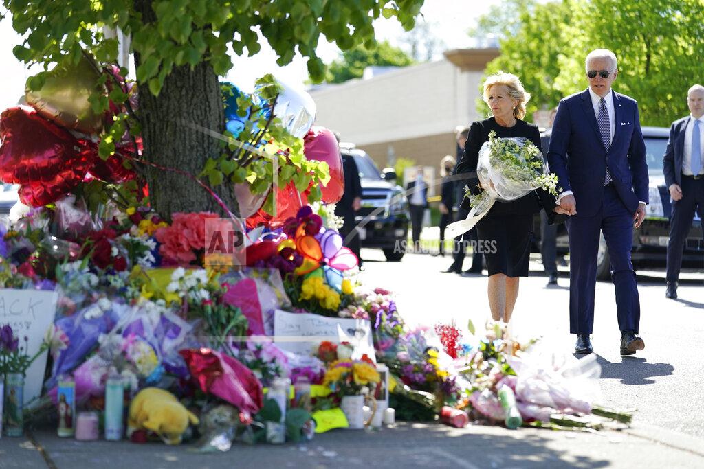 Andrew Harnik President Joe Biden and first lady Jill Biden visit the scene of a shooting at a supermarket to pay respects and speak to families of the victims of Saturday's shooting in Buffalo, N.Y., Tuesday, May 17, 2022. (AP Photo/Andrew Harnik)