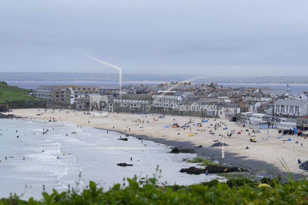 Alastair Grant Surfers and sunbathers enjoy the beach at St. Ives, Cornwall, England, Thursday, June 10, 2021. G7 leaders and guests will meet in the the Cornish resort of Carbis Bay starting Friday, June 11, 2021. (AP Photo/Alastair Grant)