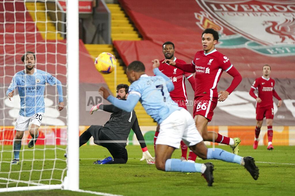 Jon Super Manchester City's Raheem Sterling, foreground, scores his side's third goal during the English Premier League soccer match between Liverpool and Manchester City at Anfield Stadium, Liverpool, England, Sunday, Feb. 7, 2021. (AP photo/Jon Super, Pool)