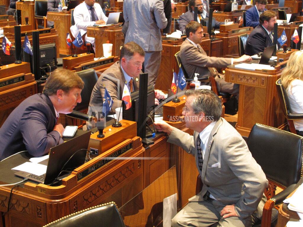 Melinda Deslatte Reps. Jean-Paul Coussan, R-Lafayette, left; Stephen Dwight, R-Lake Charles, center; and Jerome "Zee" Zeringue, R-Houma, speak on the House floor on the final day of the regular legislative session on Monday, June 1, 2020, in Baton Rouge, La. (AP Photo/Melinda Deslatte)