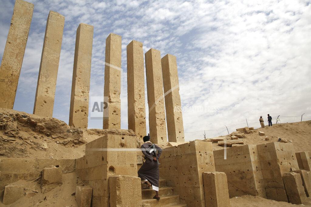 Jon Gambrell FILE - In this Feb. 3, 2018, file photo, a militiaman allied to Yemen's internationally recognized government walks through the Awwam Temple, also known as the Mahram Bilqis, in Marib, Yemen. The battle for the ancient desert city has become key to understanding wider tensions now inflaming the Middle East and the challenges facing any efforts by President Joe Biden’s administration to shift U.S. troops out of the region. (AP Photo/Jon Gambrell, File)
