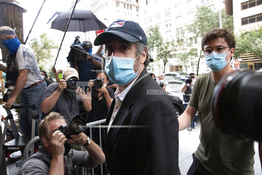 Mark Lennihan Michael Cohen, President Donald Trump's former personal attorney, returns to his apartment after being released from prison, Friday, July 24, 2020, in New York. District Judge Alvin Hellerstein ordered Cohen released on parole saying he believes the government retaliated against him for writing a book about Trump. (AP Photo/Mark Lennihan)