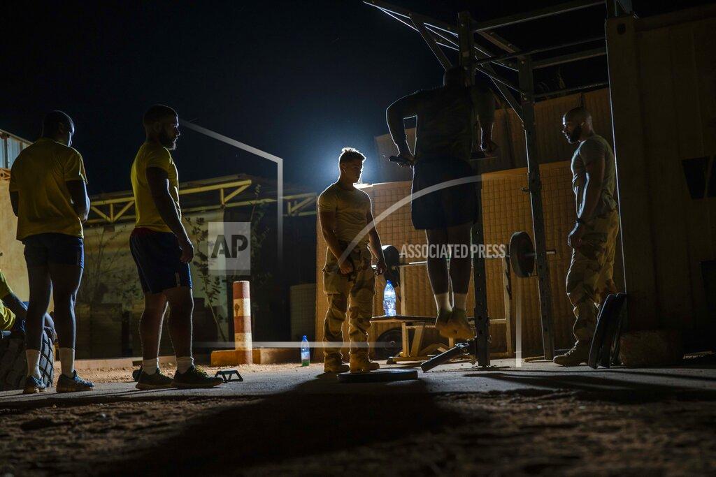 Uncredited French Barkhane force soldiers work out at their base in Gao, Mali Tuesday June 8, 2021. After France suspended joint military operations with Malian forces after the junta led by Col. Assimi Goita retook control of Mali's transitional government May 24 2021, French President Emmanuel Macron announced at a press conference Thursday June 10, 2021 That operation Barkhane would end and be replaced by support for local partners and counter terrorism. (AP Photo/Jerome Delay)