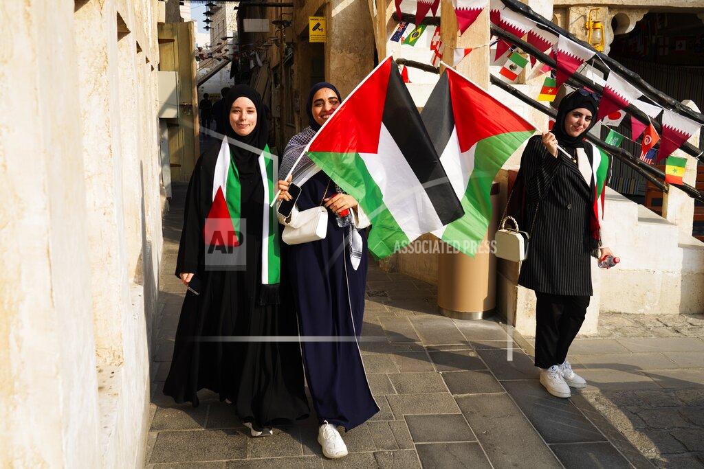 Jon Gambrell Palestinian women wave the Palestinian flag ahead of the FIFA World Cup in Doha, Qatar, Saturday, Nov. 19, 2022. (AP Photo/Jon Gambrell)