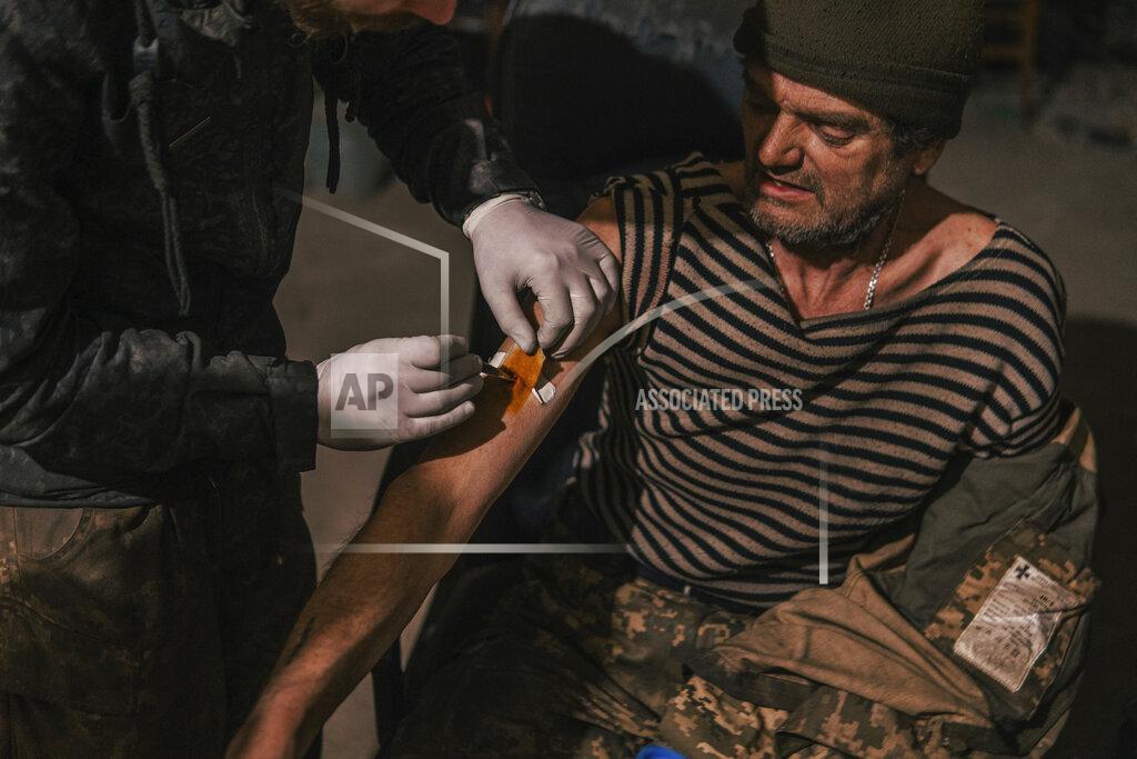 Dmytro 'ORest' Kozatskyi In this photo provided by Azov Special Forces Regiment of the Ukrainian National Guard Press Office, an Azov Special Forces Regiment's serviceman receives treatment inside the Azovstal steel plant in Mariupol, Ukraine, Tuesday, May 10, 2022. (Dmytro 'Orest' Kozatskyi/Azov Special Forces Regiment of the Ukrainian National Guard Press Office via AP)