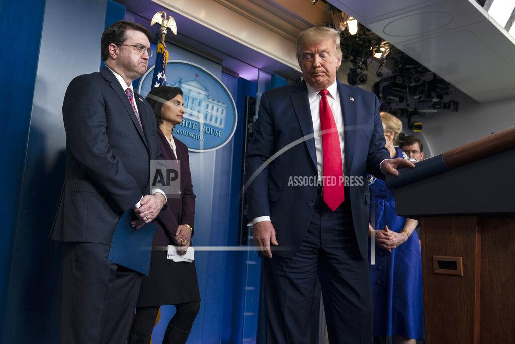 Evan Vucci President Donald Trump walks from the podium after a press briefing with the coronavirus task force, at the White House, Wednesday, March 18, 2020, in Washington. Watching are Veterans Affairs Secretary Robert Wilkie, and Administrator of the Centers for Medicare and Medicaid Services Seema Verma.(AP Photo/Evan Vucci)