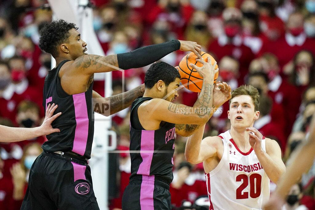 Andy Manis Penn State's Sam Sessoms, center, and Greg Lee, left, grab a defensive rebound against Wisconsin's Ben Carlson (20) during the first half of an NCAA college basketball game Saturday, Feb. 5, 2022, in Madison, Wis. (AP Photo/Andy Manis)