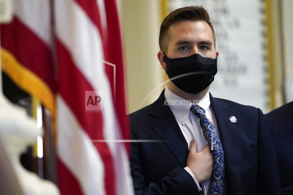 Robert F. Bukaty House Speaker Ryan Fecteau, D-Biddeford, stands for the National Anthem during the first legislative session in the State House since the proceedings were moved to the more spacious Augusta Civic Center, Wednesday, June 2, 2021, in Augusta, Maine. (AP Photo/Robert F. Bukaty)