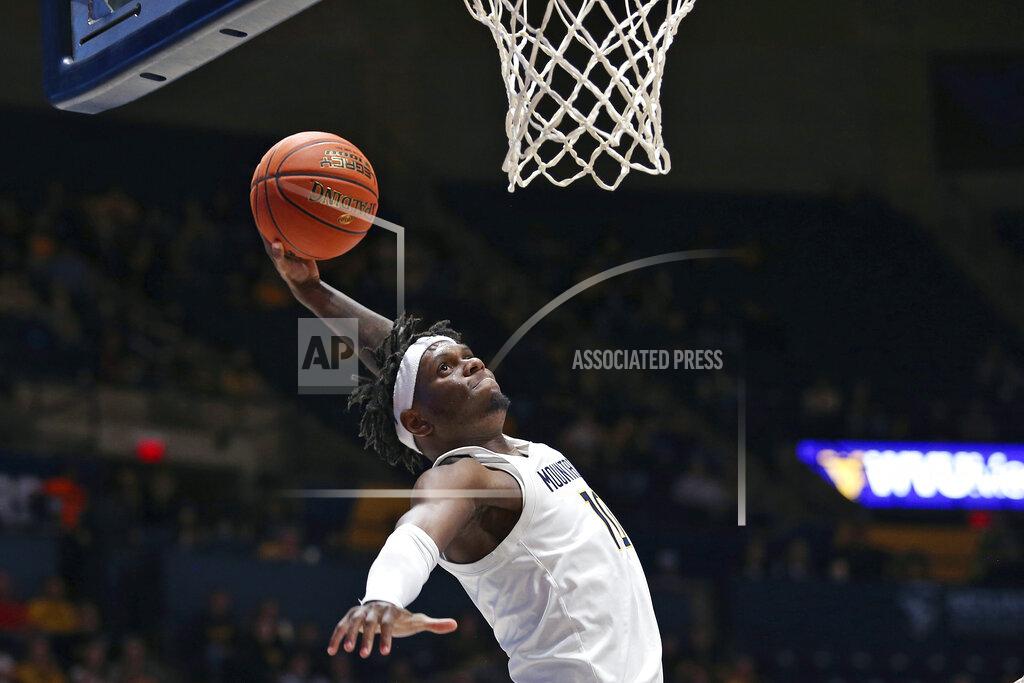 Kathleen Batten West Virginia guard Malik Curry (10) goes to the basket against Oakland during the second half of an NCAA college basketball game in Morgantown, W.Va., Tuesday, Nov. 9, 2021. (AP Photo/Kathleen Batten)