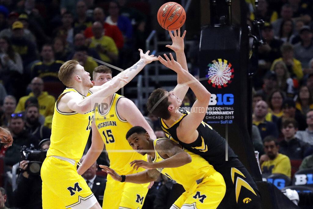 Nam Y. Huh Iowa's Luka Garza tries to grab a rebound on top of Michigan's Charles Matthews (1) as Michigan's Ignas Brazdeikis (13) reaches for it during the second half of an NCAA college basketball game in the quarterfinals of the Big Ten Conference tournament, Friday, March 15, 2019, in Chicago. (AP Photo/Nam Y. Huh)