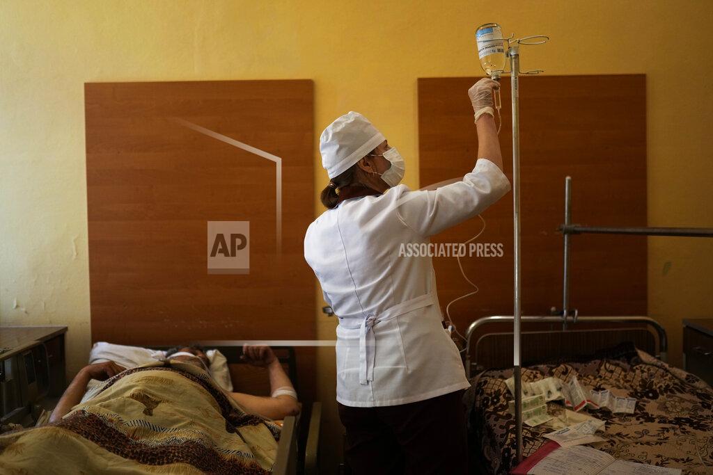 Francisco Seco A nurse tends to a patient after he underwent surgery for injuries to his leg and abdomen caused by a mine explosion in Severodonetsk, at Kostyantynivka hospital, in Kostyantynivka, eastern Ukraine, Monday, May 23, 2022. (AP Photo/Francisco Seco)