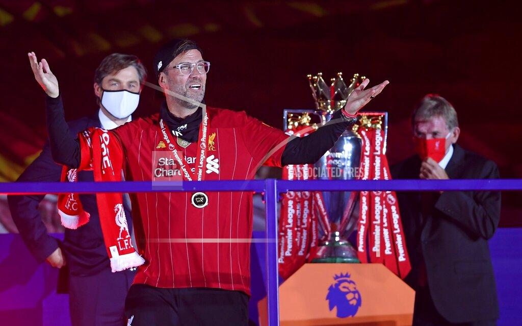 Laurence Griffiths Liverpool's manager Jurgen Klopp celebrates after getting his winners medal following the English Premier League soccer match between Liverpool and Chelsea at Anfield Stadium in Liverpool, England, Wednesday, July 22, 2020. Liverpool are champions of the EPL for the season 2019-2020. The trophy is presented at the teams last home game of the season. Liverpool won the match against Chelsea 5-3. (Laurence Griffiths, Pool via AP)