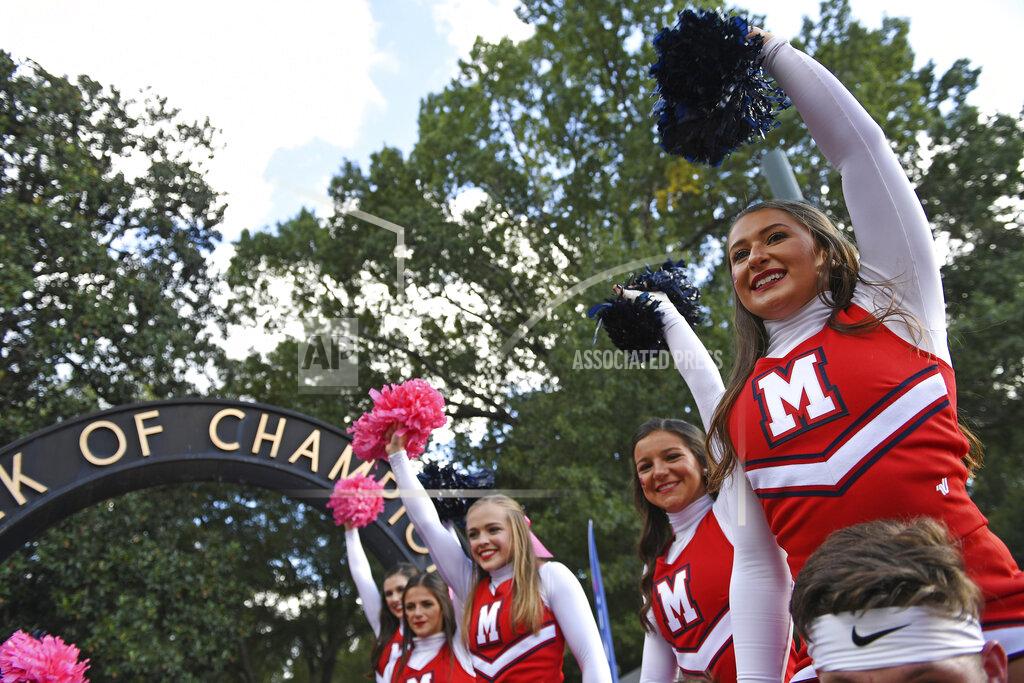 Thomas Graning Mississippi cheerleaders cheer during the Walk of Champions in the Grove before an NCAA college football game between Mississippi and Texas A&M in Oxford, Miss., Saturday, Oct. 19, 2019. Football is being played in the Power Five conferences, but many of the longstanding traditions that go along with the games are on hold during the coronavirus pandemic. (AP Photo/Thomas Graning)
